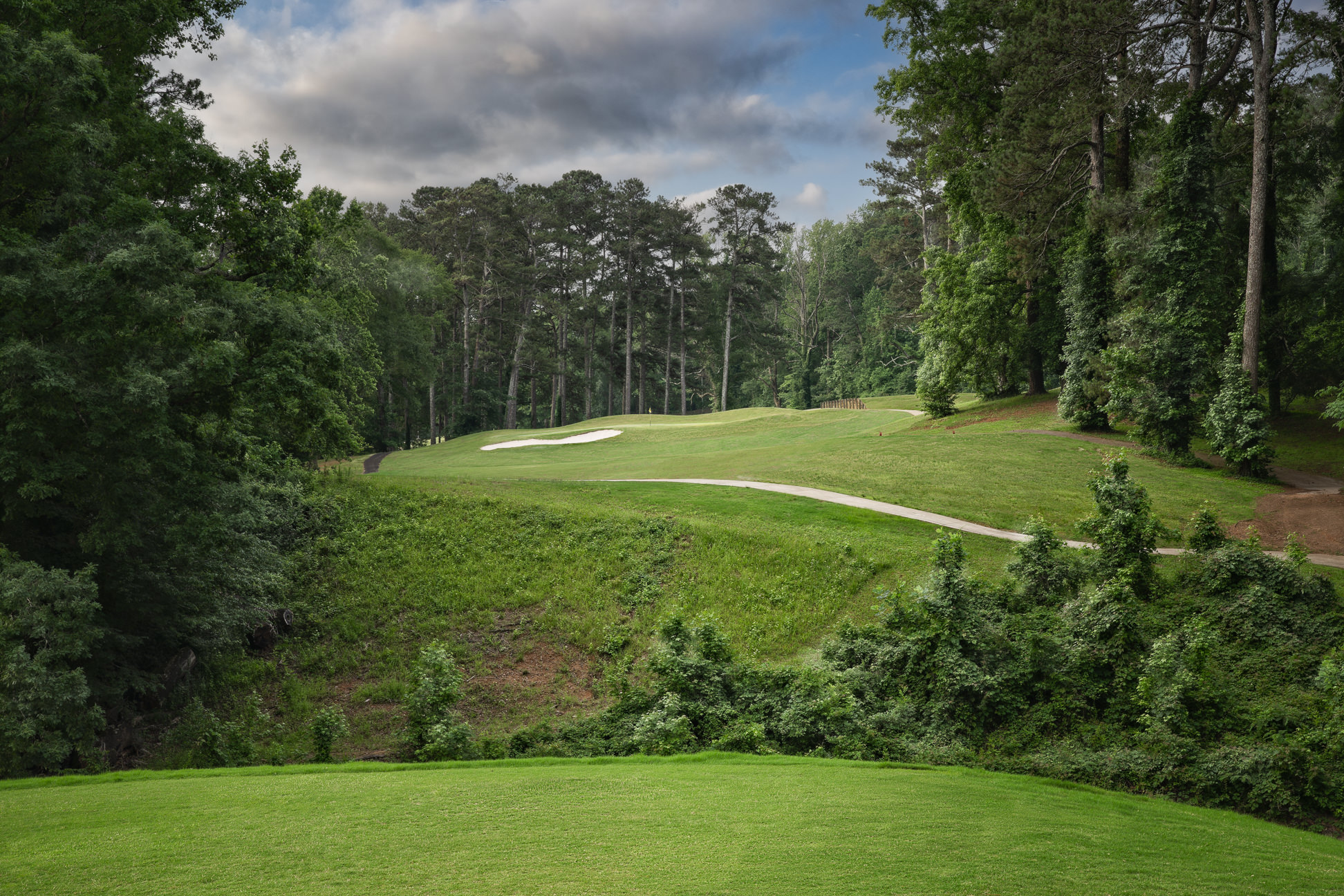 Course greens with clouds coming in 